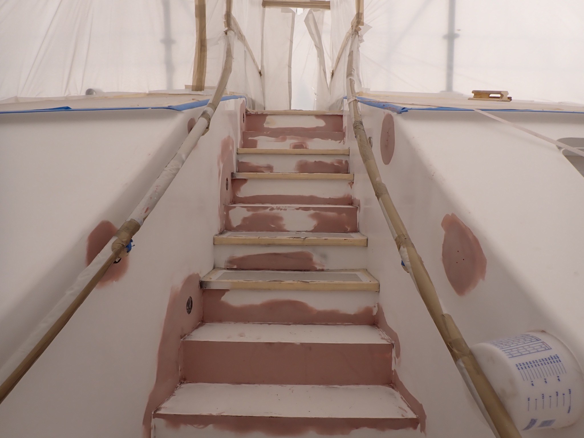 Yacht stairway with localized fairing and repair areas prepared for coating