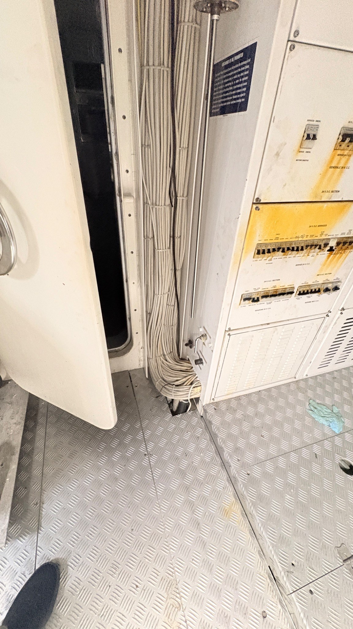 Rust staining and corrosion around an electrical distribution enclosure aboard a yacht