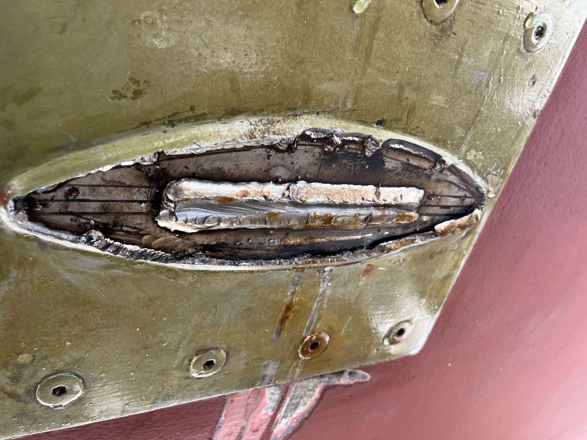 Opened yacht structural detail exposing underlying metal fabrication and repair work