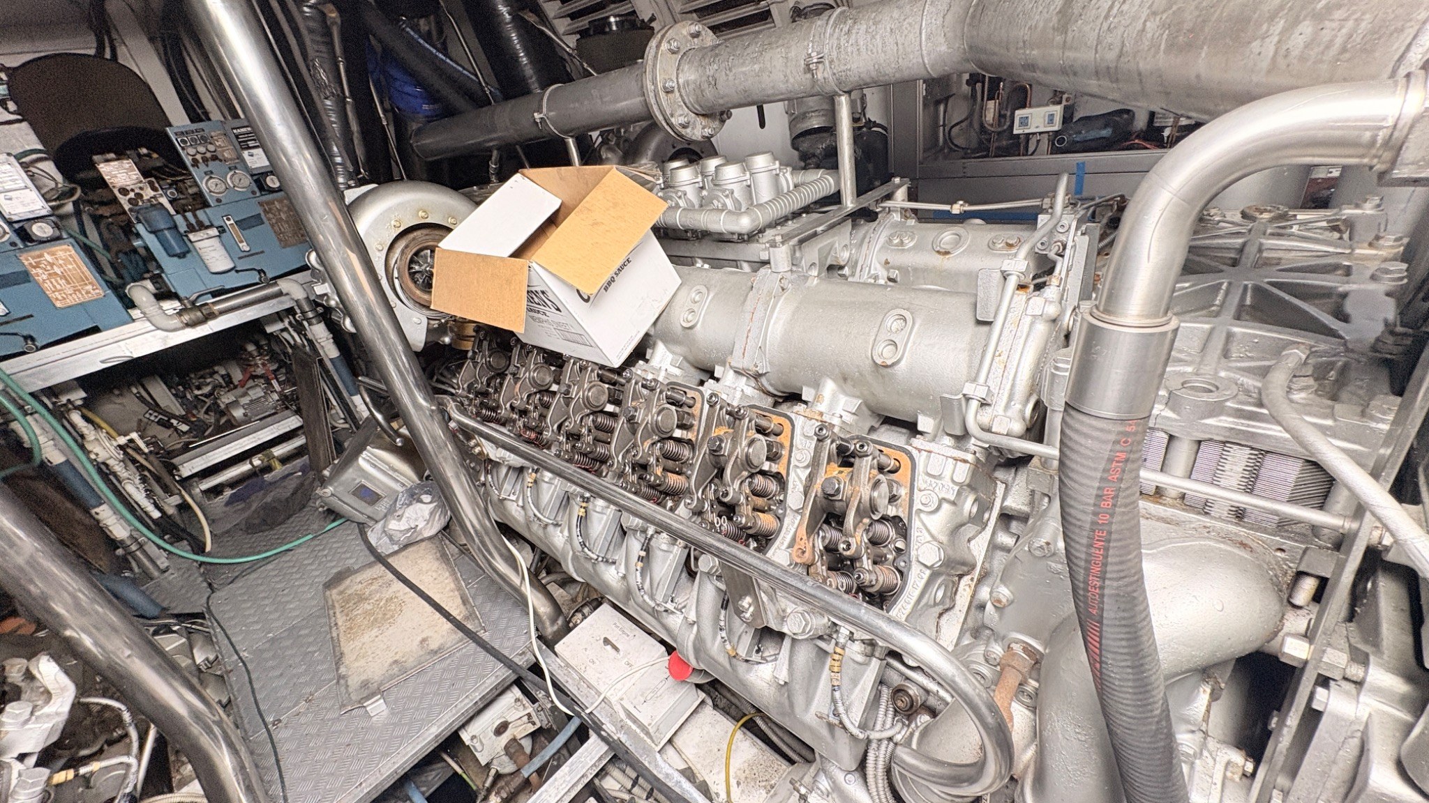 Large yacht diesel engine with valve gear exposed during technical inspection