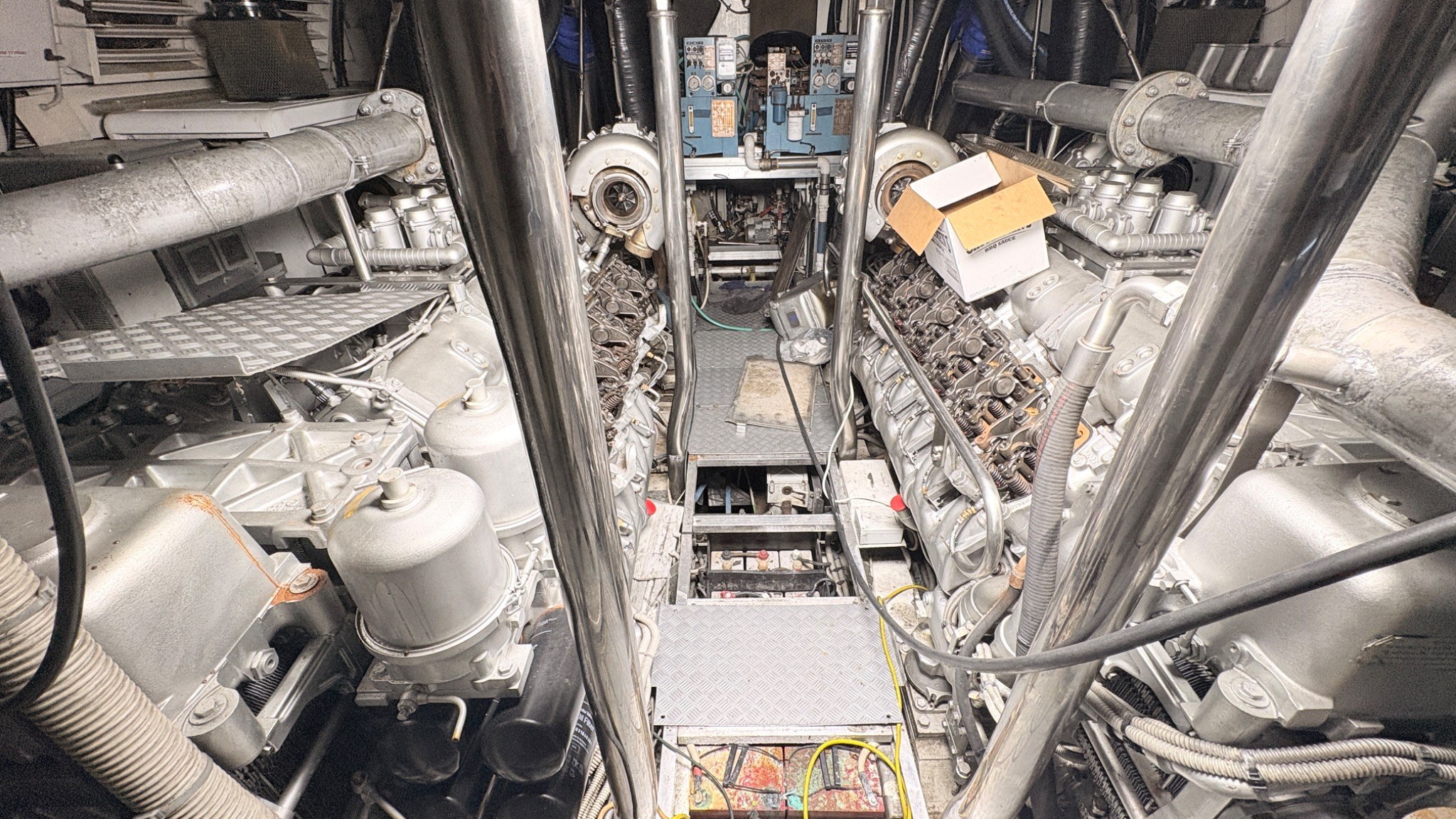 Large yacht engine room with main engines open for inspection