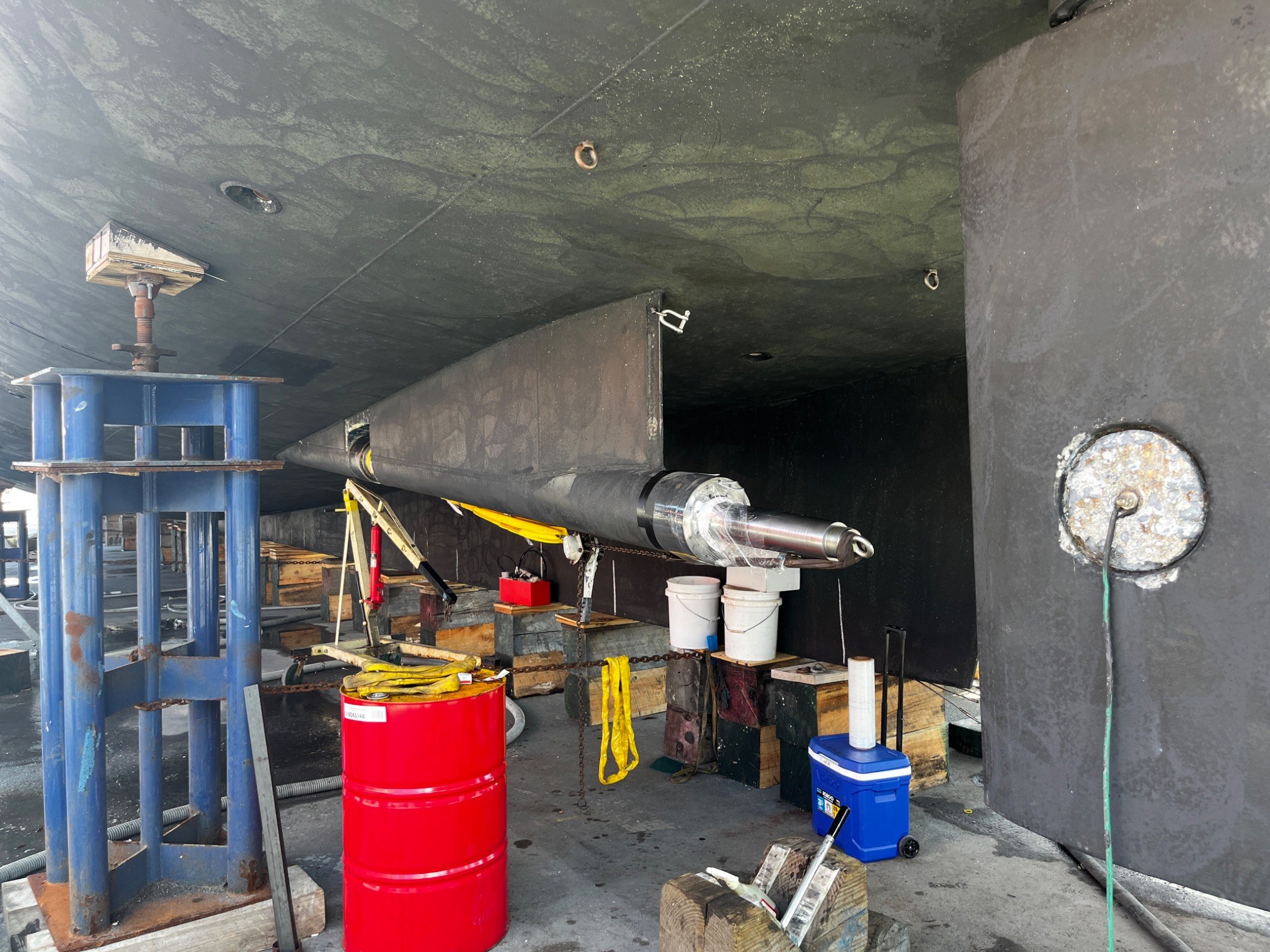Large yacht shafting and stern gear exposed ashore during shipyard work
